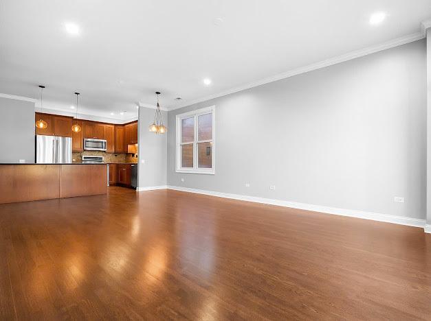 1355 W Washington Blvd Unit 4D, Chicago, IL 60607 - unfurnished living room featuring ornamental molding, dark wood-style flooring, a chandelier, and recessed lighting