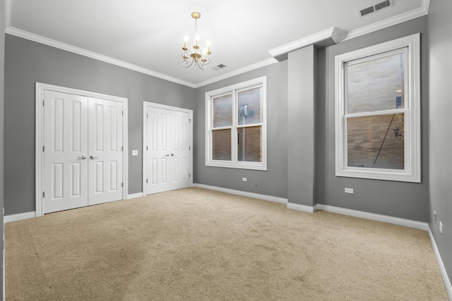 1355 W Washington Blvd Unit 4D, Chicago, IL 60607 - unfurnished bedroom featuring multiple closets, carpet flooring, a chandelier, and crown molding