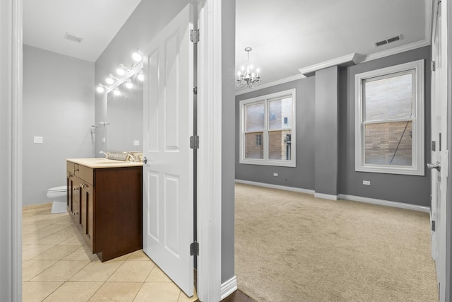 1355 W Washington Blvd Unit 4D, Chicago, IL 60607 - bathroom featuring vanity, a chandelier, crown molding, and tile patterned flooring