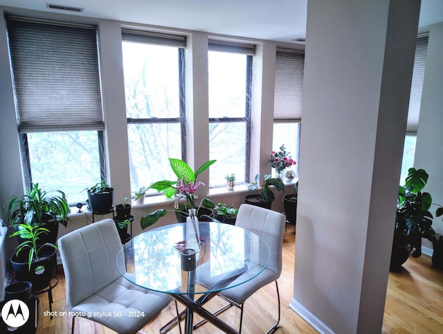 dining space with wood finished floors