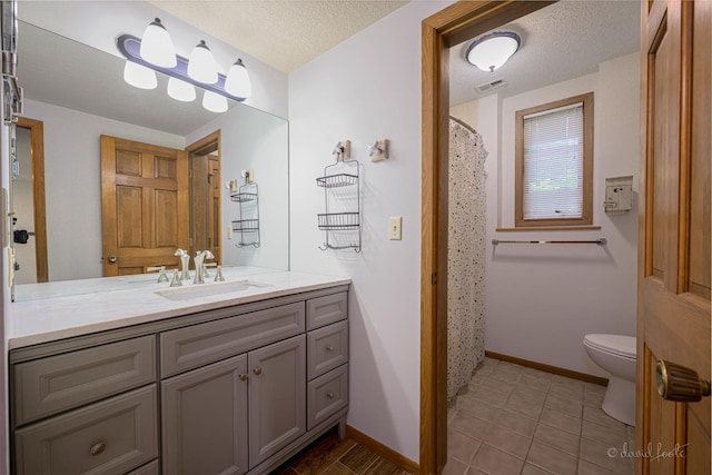 22 Valleywood Ln Unit 22, Galena, IL 61036 - bathroom with toilet, vanity, baseboards, tile patterned floors, and a textured ceiling