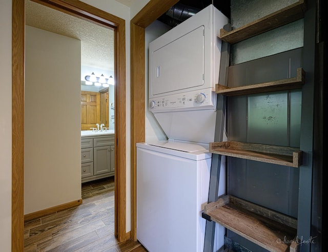 22 Valleywood Ln Unit 22, Galena, IL 61036 - laundry area featuring estacked washer and dryer, wood finished floors, and baseboards