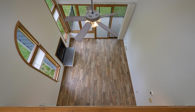 22 Valleywood Ln Unit 22, Galena, IL 61036 - unfurnished living room with a ceiling fan, wood finished floors, and a towering ceiling