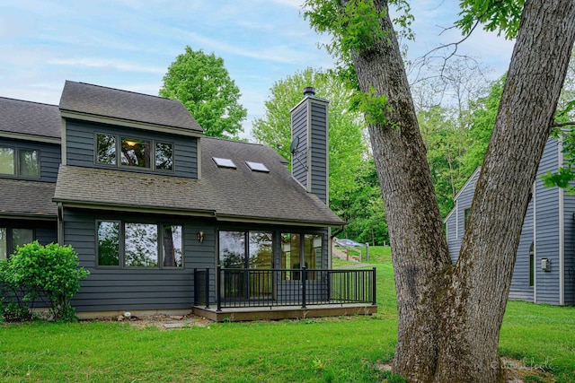 22 Valleywood Ln Unit 22, Galena, IL 61036 - back of property with a chimney, a lawn, a deck, and roof with shingles