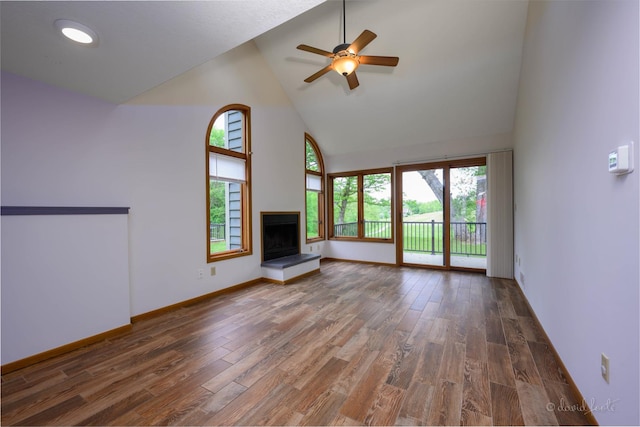 22 Valleywood Ln Unit 22, Galena, IL 61036 - unfurnished living room featuring high vaulted ceiling, healthy amount of natural light, wood finished floors, and a fireplace with raised hearth