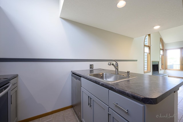 22 Valleywood Ln Unit 22, Galena, IL 61036 - kitchen featuring a sink, a peninsula, appliances with stainless steel finishes, tile counters, and light tile patterned floors