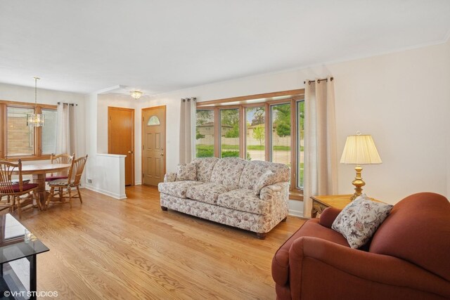 43 N Mount Prospect Rd, Des Plaines, IL 60016 - living area featuring a chandelier, light wood-style floors, and baseboards