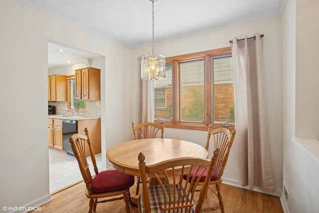 43 N Mount Prospect Rd, Des Plaines, IL 60016 - dining area featuring a chandelier, light wood-style flooring, ornamental molding, and baseboards