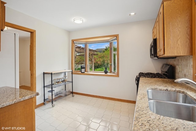 43 N Mount Prospect Rd, Des Plaines, IL 60016 - kitchen featuring a sink, recessed lighting, baseboards, light stone counters, and light tile patterned floors