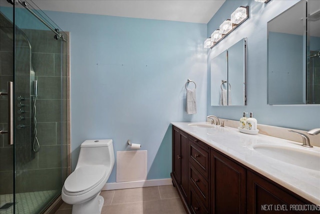1307 S Wabash Ave Unit 402, Chicago, IL 60605 - full bathroom featuring double vanity, tile patterned floors, toilet, tiled shower, and baseboards