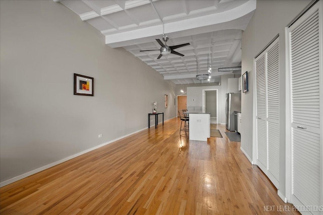 1307 S Wabash Ave Unit 402, Chicago, IL 60605 - unfurnished living room with ceiling fan, baseboards, coffered ceiling, light wood-style flooring, and beamed ceiling