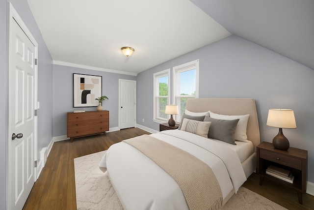 bedroom with dark wood-type flooring, baseboards, and lofted ceiling