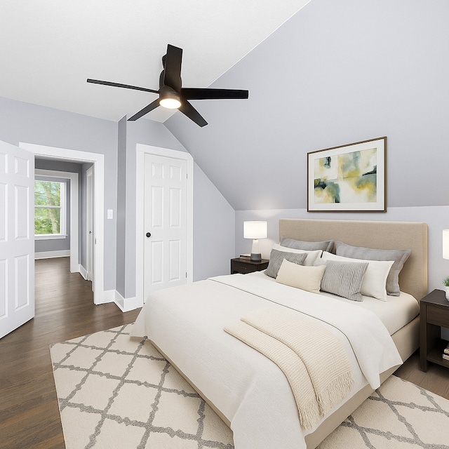 bedroom featuring wood finished floors, lofted ceiling, baseboards, a ceiling fan, and a closet