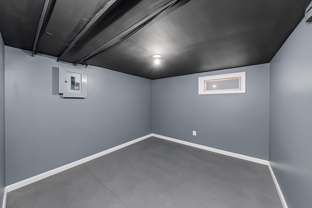 finished below grade area featuring baseboards and electric panel