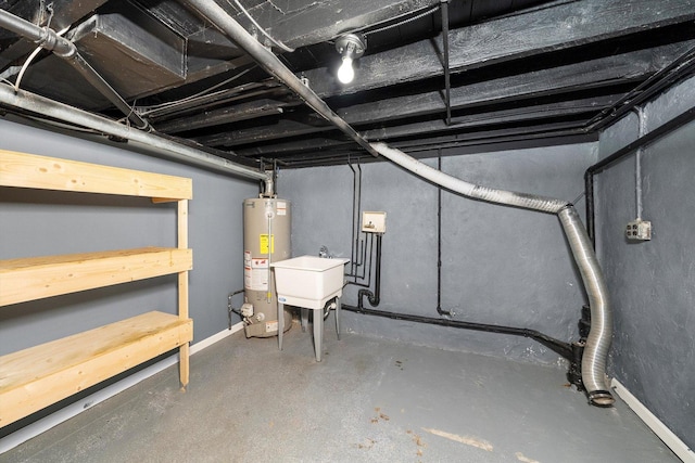 unfinished basement featuring gas water heater and a sink