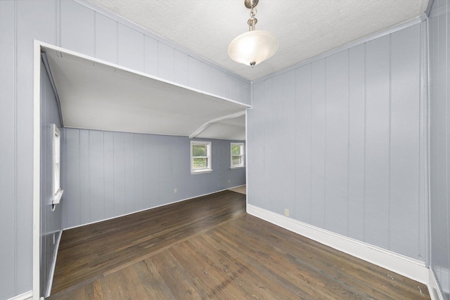 unfurnished room with dark wood-style floors and a textured ceiling
