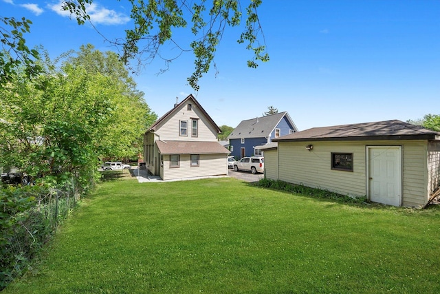 rear view of house with an outdoor structure