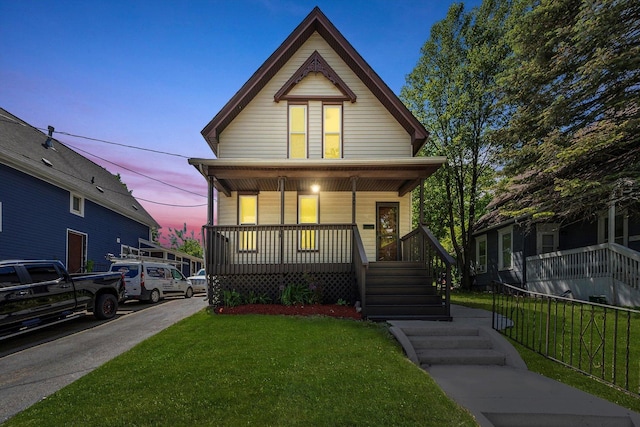 view of front of house featuring covered porch and a front lawn