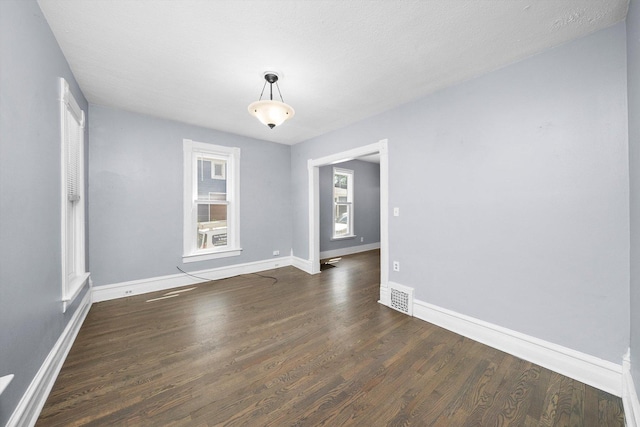 unfurnished room featuring wood finished floors and baseboards