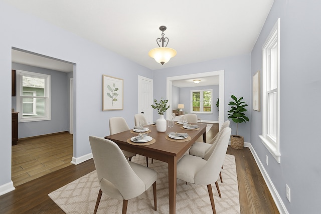 dining room with wood finished floors and baseboards