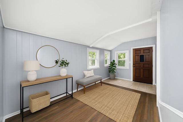 entryway with wood-type flooring and vaulted ceiling