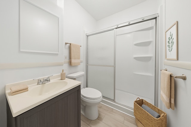 full bath featuring a shower stall, toilet, and vanity