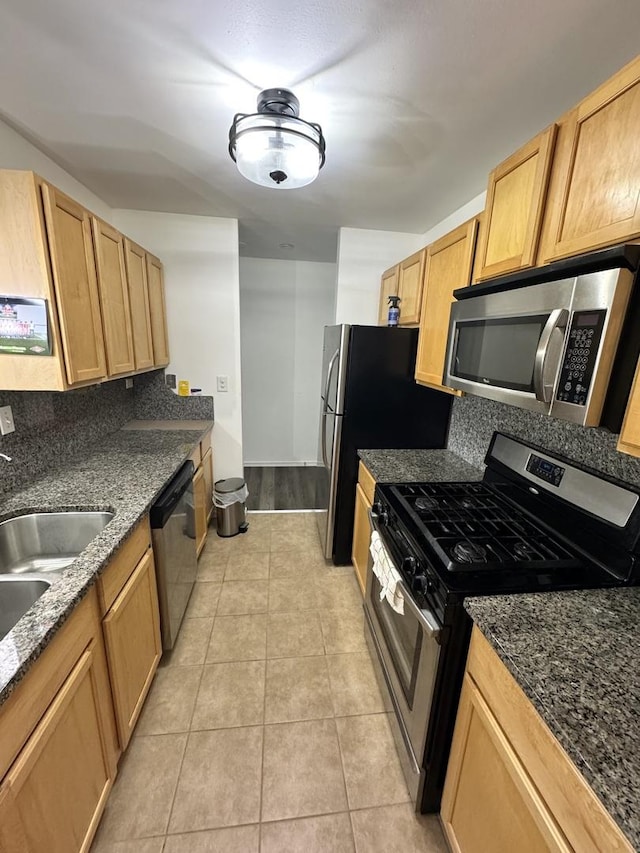 1919 Prairie Sq Unit 231, Schaumburg, IL 60173 - kitchen with stainless steel appliances, tasteful backsplash, light tile patterned floors, and dark stone counters