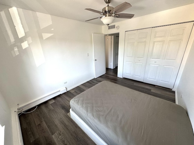 1919 Prairie Sq Unit 231, Schaumburg, IL 60173 - bedroom with dark wood-style floors, a closet, a ceiling fan, baseboards, and a baseboard heating unit