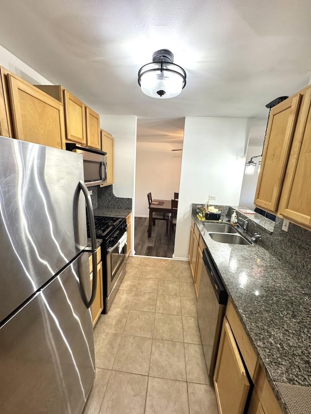 1919 Prairie Sq Unit 231, Schaumburg, IL 60173 - kitchen with appliances with stainless steel finishes, a sink, dark stone counters, light tile patterned flooring, and tasteful backsplash