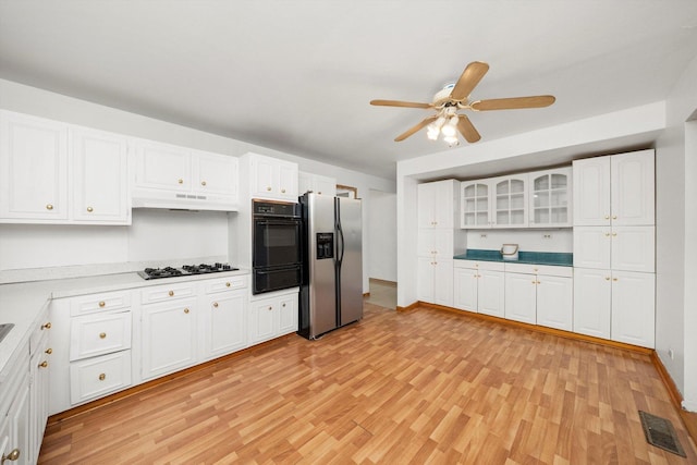 17714 Dogwood Ln, Hazel Crest, IL 60429 - kitchen featuring stainless steel fridge with ice dispenser, black oven, a warming drawer, light wood-style floors, and white cabinetry