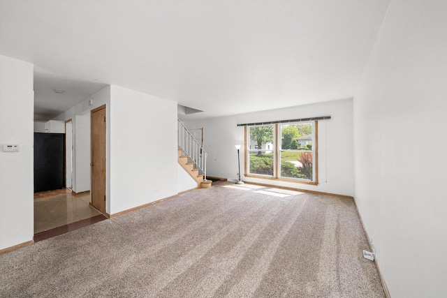17714 Dogwood Ln, Hazel Crest, IL 60429 - unfurnished living room featuring carpet, stairs, and baseboards