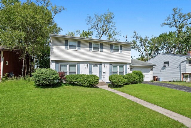 17714 Dogwood Ln, Hazel Crest, IL 60429 - colonial home with driveway, a front yard, and brick siding