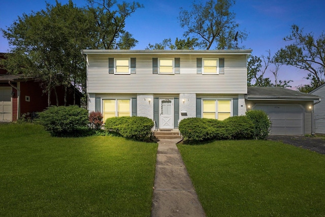17714 Dogwood Ln, Hazel Crest, IL 60429 - colonial inspired home with an attached garage, a front yard, and driveway
