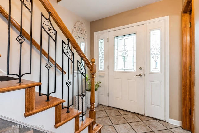 3724 Monitor Dr, Hanover Park, IL 60133 - foyer with stairway, light tile patterned floors, and baseboards