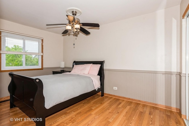 3724 Monitor Dr, Hanover Park, IL 60133 - bedroom featuring a wainscoted wall, wood finished floors, a ceiling fan, and baseboards