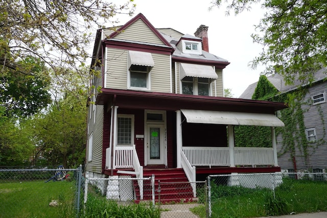 7225 S Princeton Ave, Chicago, IL 60621 - victorian home featuring covered porch, a chimney, and a fenced front yard