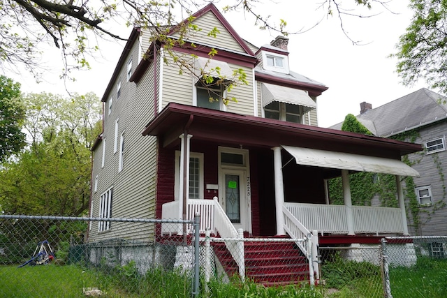 7225 S Princeton Ave, Chicago, IL 60621 - victorian house featuring a porch, a fenced front yard, and a chimney