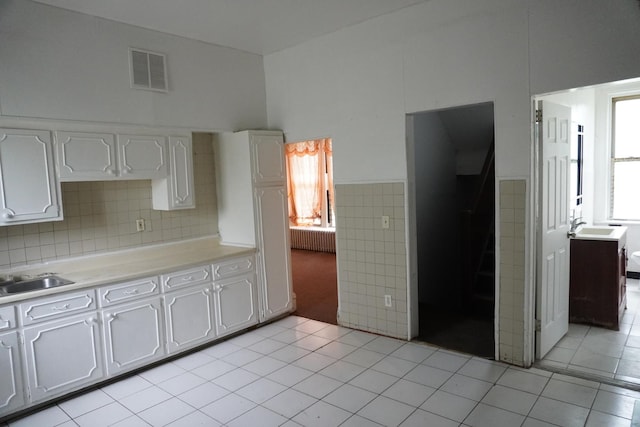 7225 S Princeton Ave, Chicago, IL 60621 - kitchen featuring plenty of natural light, light tile patterned flooring, a sink, light countertops, and wainscoting