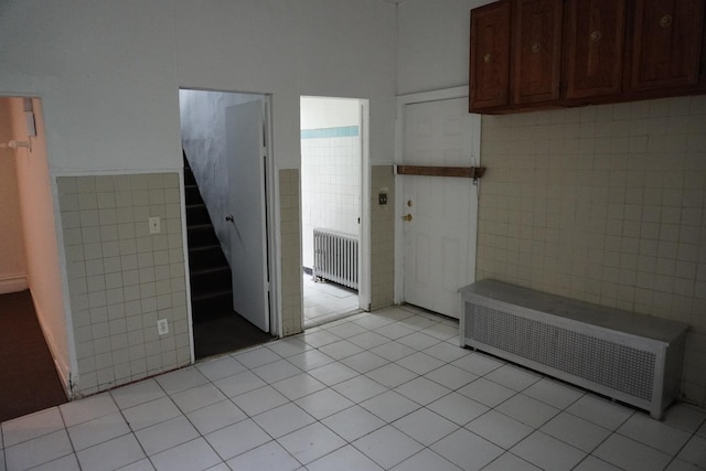 7225 S Princeton Ave, Chicago, IL 60621 - kitchen featuring tile walls, radiator heating unit, light tile patterned floors, and wainscoting