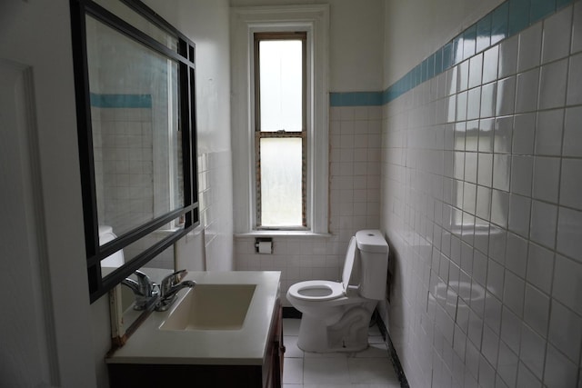 7225 S Princeton Ave, Chicago, IL 60621 - bathroom with tile walls, plenty of natural light, toilet, vanity, and tile patterned flooring