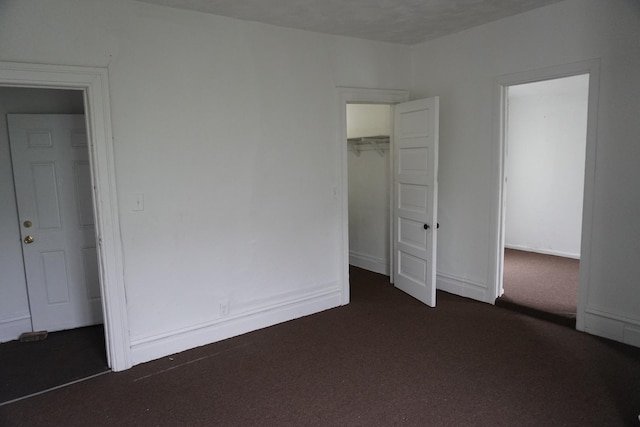 7225 S Princeton Ave, Chicago, IL 60621 - unfurnished bedroom featuring dark colored carpet, a walk in closet, and a closet