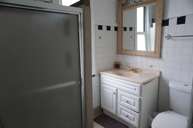 7225 S Princeton Ave, Chicago, IL 60621 - bathroom featuring tile walls, a stall shower, toilet, and vanity
