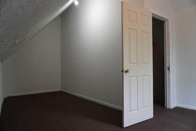 7225 S Princeton Ave, Chicago, IL 60621 - additional living space with lofted ceiling, dark carpet, and baseboards