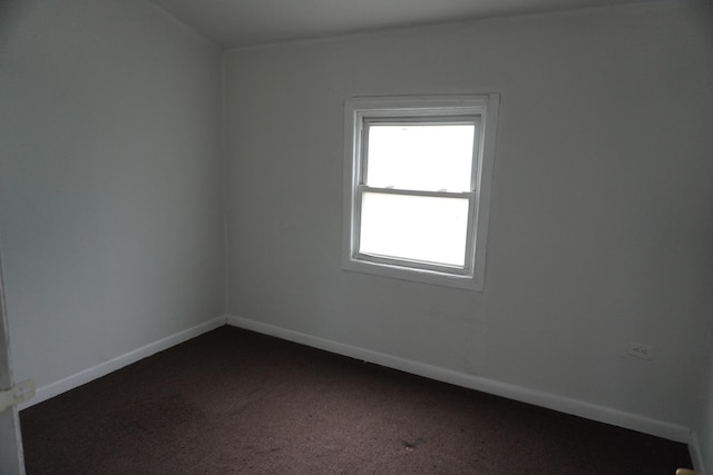 7225 S Princeton Ave, Chicago, IL 60621 - unfurnished room featuring baseboards and dark colored carpet