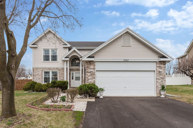 1947 Lucille Ln, Hanover Park, IL 60133 - traditional-style house with brick siding, asphalt driveway, and a garage