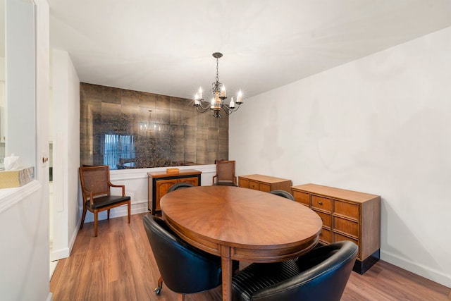 1615 E Central Rd Unit 410B, Arlington Heights, IL 60005 - dining space featuring a chandelier, wood finished floors, and baseboards