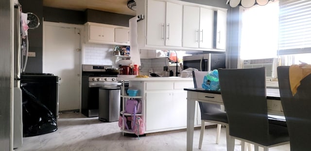 3355 W 65th St, Chicago, IL 60629 - kitchen with stainless steel appliances, plenty of natural light, and white cabinetry