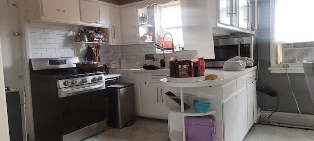 3355 W 65th St, Chicago, IL 60629 - kitchen featuring stainless steel appliances, white cabinets, light countertops, tasteful backsplash, and cooling unit