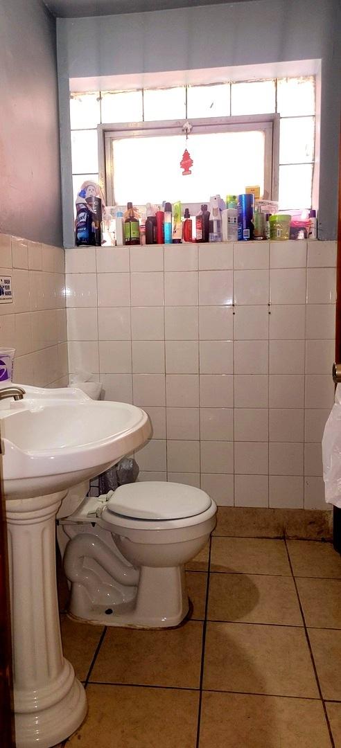 3355 W 65th St, Chicago, IL 60629 - bathroom featuring tile walls, tile patterned flooring, and toilet