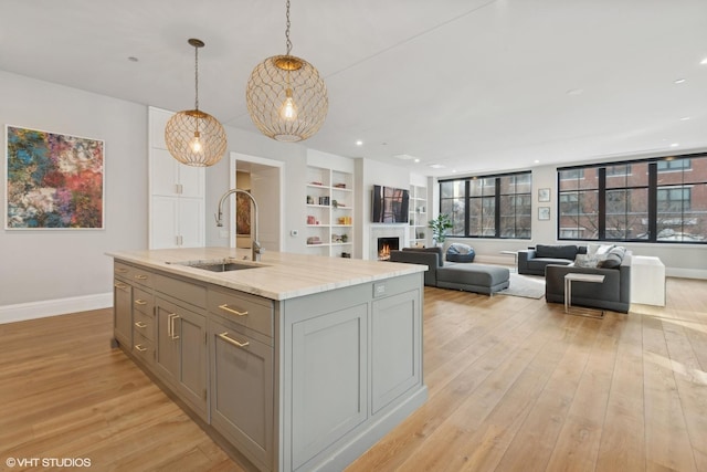 1109 W Washington Blvd Unit 2B, Chicago, IL 60607 - kitchen with a sink, gray cabinetry, baseboards, light wood-style floors, and recessed lighting